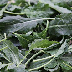 Baby kale salad with purple carrot ribbons, kumquats and sesame vinaigrette