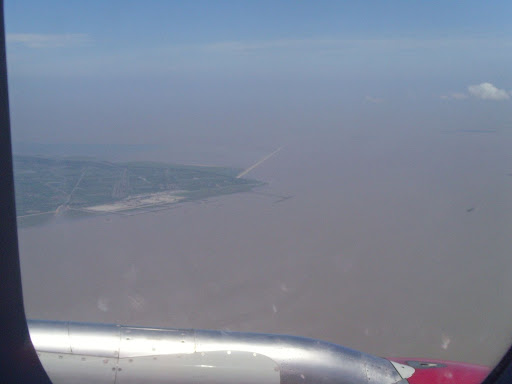 Approaching Shanghai Pudong Airport. We can see from far the DongHai bridge (????). is the longest cross-sea bridge in the world. It was completed on December 10, 2005. It has a total length of 32.5 kilometres (20.2 miles) and connects Shanghai and the offshore Yangshan deep-water port in China. Most of the bridge is a low-level viaduct. There are also cable-stayed sections to allow for the passage of large ships, largest with span of 420 m.