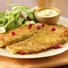 Seared Lemon Pepper Tilapia with Creamy Pumpkin Seed Vinaigrette Salad topped with Pomegranate Seeds
