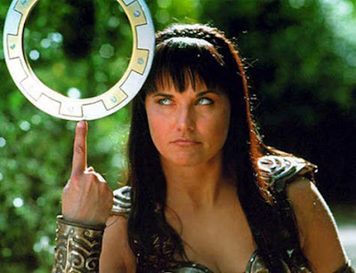 Xena balances her chakram on her upheld index finger