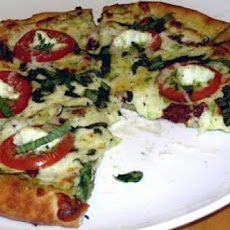 Pesto Pizza With Sliced Tomatoes