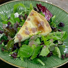 Garlic and Rosemary Goat Cheese Tart Served with Spring Greens and Black Olive Vinaigrette