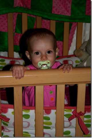 Finley standing in crib