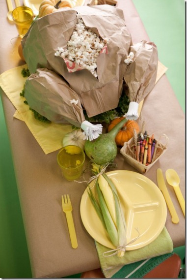 Thanksgiving kids table decorating and activity ideas--brown paper turkey stuffed with popcorn