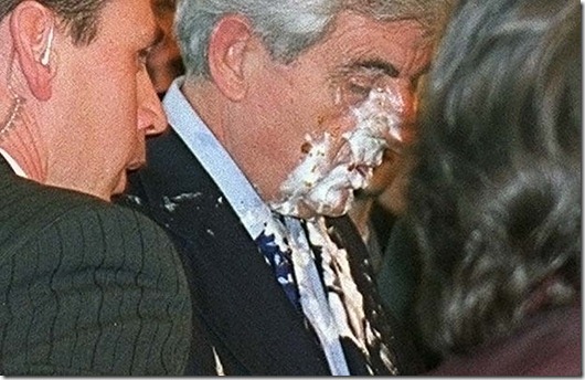ALL...SAL01 - 20020324 - PARIS, FRANCE : French right wing presidential candidate Jean-Pierre Chevenement (C) reacts after being hit in the face with a pineapple-cream pie by notorious Belgian social activist Noel "Le Gloupier" Godin as the former interior minister dedicated his book, "The Courage to Decide", at the Paris Salon du Livre 24 March 2002. The Gloupier, who has cream-pied technology king Bill Gates and other personalities around Europe, was arrested. Chevenement, a distant third in the polls behind incumbent Jacques Chirac, a conservative, and Prime Minister Lionel Jospin, a Socialist, heads his own fraction party, the Pole Republicain.    EPA PHOTO      AFP/PASCAL LEGRAND/lab-iw/w