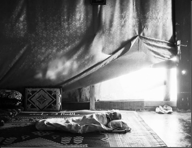 A Syrian baby sleeps inside his family's tent in the Bekaa Valley, Lebanon. (Moises Saman/Magnum Photos for Save the Children)