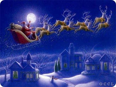 Santa_claus_flying_beside_moon_over_hosues_in_night_snow_reindeer_Christmas_gifts_photo