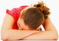 Girl with red hair sleeping on the table Girl with red hair sleeping on the table