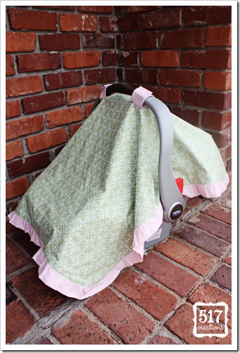side of pink and green ruffled car seat canopy