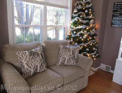 crowded living room corner Christmas tree