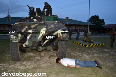 Hubby trying out planking under an army tank in the 73rd Infantry Battalion grounds in Sarangani