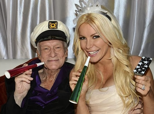 Octogenarian Playboy founder Hugh Hefner poses with his bride Crystal Harris as they ring in the new year at their wedding in Beverly Hills...Octogenarian Playboy founder Hugh Hefner poses with his bride Crystal Harris as they ring in the new year at their wedding at the Playboy Mansion in Beverly Hills, California in this handout photo taken on December 31, 2012. Hefner briefly swapped his iconic silk pajamas for a tuxedo to marry Harris, the one-time "runaway bride" who followed through this time at the New Year's Eve wedding. The couple tied the knot more than a year after their planned 2011 wedding was scuttled when Harris got cold feet. REUTERS/Elayne Lodge/PEI/Handout (UNITED STATES - Tags: ENTERTAINMENT MEDIA) NO SALES. NO ARCHIVES. FOR EDITORIAL USE ONLY. NOT FOR SALE FOR MARKETING OR ADVERTISING CAMPAIGNS. THIS IMAGE HAS BEEN SUPPLIED BY A THIRD PARTY. IT IS DISTRIBUTED, EXACTLY AS RECEIVED BY REUTERS, AS A SERVICE TO CLIENTS