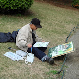 man painting at Shinjuku Gyoen in Shinjuku, Japan 