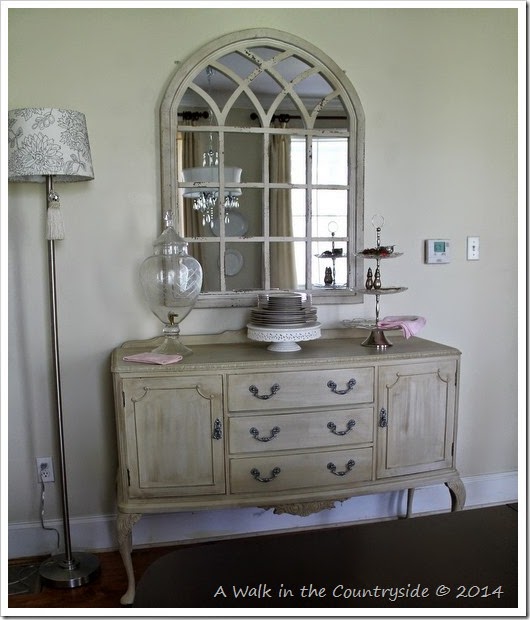 arched mirror over sideboard