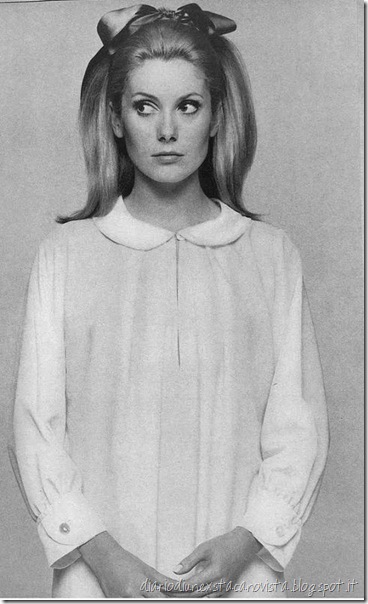 Catherine Deneuve is wearing a white crepe nightshirt with little round collar and cuffs by Sylvia Pedlar of Iris, photo by husband David Bailey for Vogue 1966