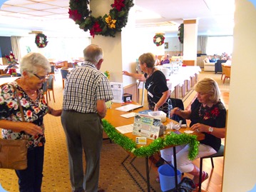 Our Events Manager, Diane Lyons (standing), and member, Margaret Black, managing the entry table and issuing raffle tickets.