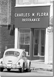 The Charles M. Flora Insurance Agency, 111 W. Franklin Street, Delphi, circa 1974. Charles bought the building on the north side of the courthouse square in 1955 and used the first floor for an office until his retirement in the 1970s. The car is John's first car, a Fontana gray 1965 Volkswagen beetle.