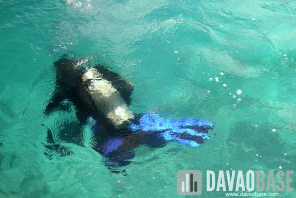 Diver underwater to help clean up Talicud's waters