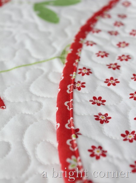 Sprouts table topper with red binding