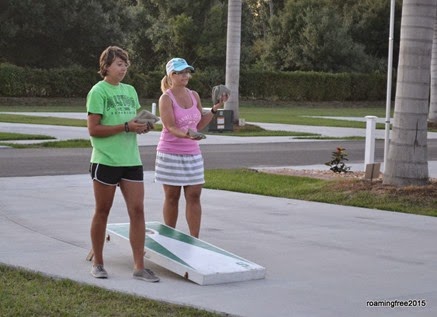 Teaching Emily and her parents how to play cornhole