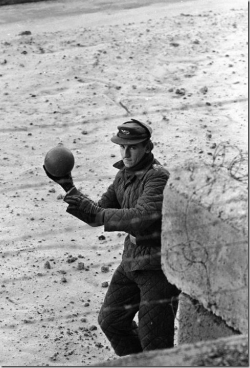 An East German guard throws a ball back to a child on the West German side of the Berlin Wall in June 1962, photographed by Paul Schutzer for LIFE.