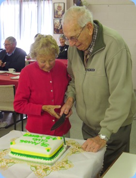 Dave Wilson and Ivy Kirker cutting the celebration cake for the 'Last Day Party'.