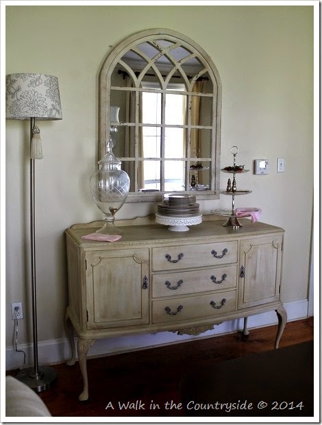 arched mirror over sideboard