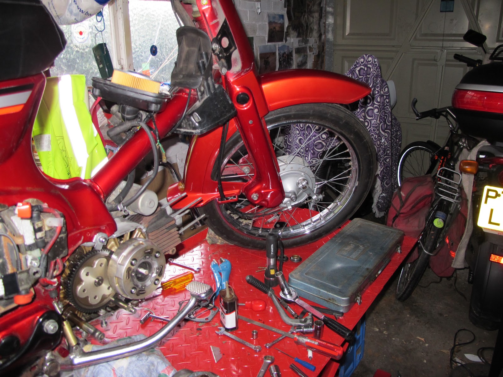 The C90 on the new bike lift and stripped down. The leg shields are off, as  is the right hand engine cover. The clutch basket is the drum shaped object  just ...