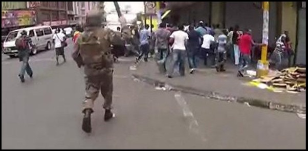 SA MILITARY MEN PATROLLING DOWNTOWN JOHANNESBURG RAIDING SHOPS OF UNARMED FOREIGN TRADERS FEB 12 2012 with cops firedept VIDEO by Adrian de Kock