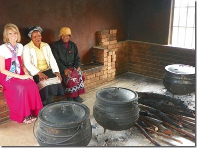 Sister Thembi Malinga - far right; she and her friend cooks lunch for the high school on these pots - 600 students