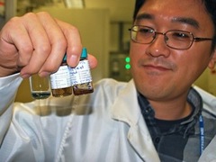 IBM Scientist holds bottles full of carbon nanotubes