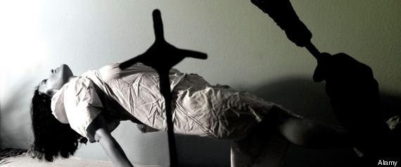 A woman levitates from her bed during an exorcism. Alamy
