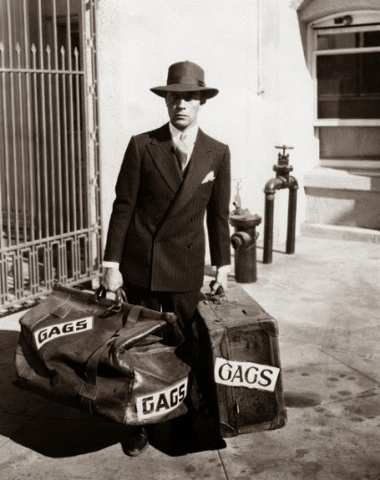 1928: Buster Keaton, the glum-faced comedian, arrives at Metro-Goldwyn-Mayer studios with two large bags of his comic ideas. Keaton will make five films a year for MGM release.