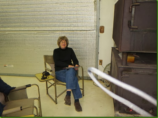 Lynne enjoying the wood stove at Little House Customs
