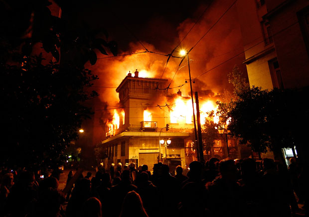 A building in Athens is engulfed in flames during the demonstration against Greece's new austerity measures, 12 February 2012. Vladimir Rys / Getty Images