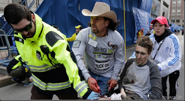 Paramedics and Carlos Arredondo (in cowboy hat) lead a gravely wounded Jeff Bauman away from the blast site. CLICK for more coverage.