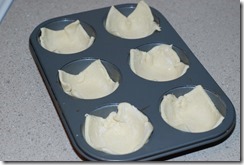 Place the puff pastry squares inside the muffin pan and prick slightly using a fork