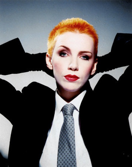 Annie Lennox wearing her classic suit and short orange hair
