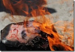 Syria protest Assad face burnt