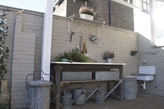 Vintage coat rack finishes a garden work area with a work bench with ...