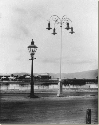 View of an old gas light alongside an electric street light in Townsville June 1922