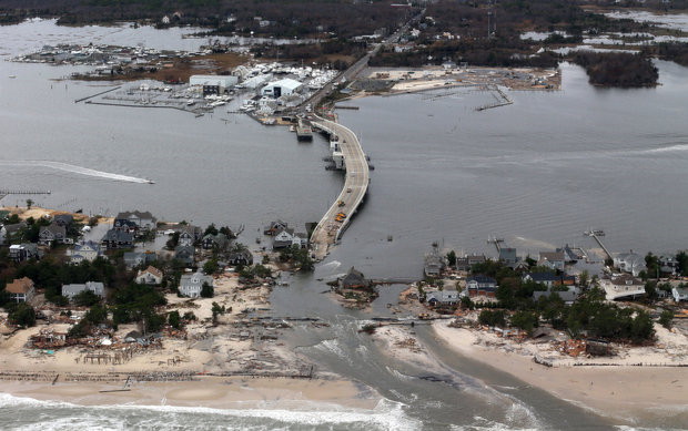 This aerial photo made from a helicopter shows storm damage from Sandy over the Atlantic Coast in Mantoloking, N.J., Wednesday, 31 October 2012. The photo was shot from a helicopter behind the helicopter carrying President Obama and New Jersey Gov. Chris Christie, as they viewed storm damage from superstorm Sandy. Doug Mills / AP Photo