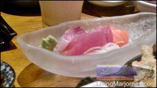Three kinds of sashimi namely raw salmon, raw tuna and crabstick