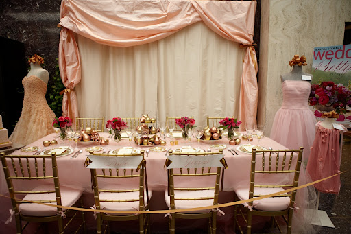 The pink and gold themed wedding reception table