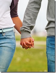 Mid section image of a couple holding hands, outdoors
