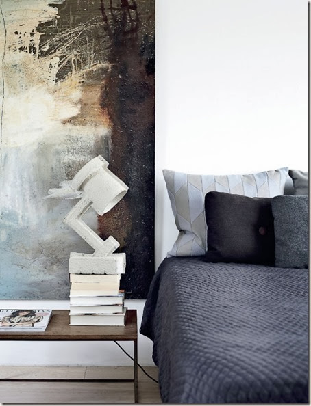 bedroom.-concrete-lamp-and-abstract-painting-in-gorgeous-tones.