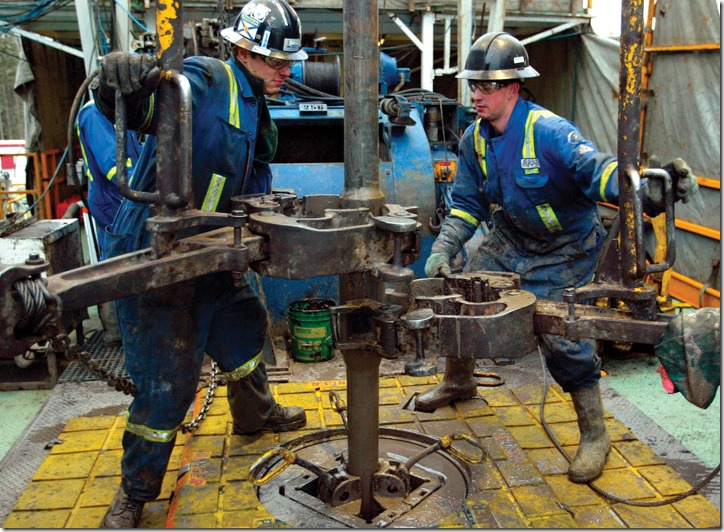 Near Grande Prairie, Alberta, Brad Scothorn, right, and Derek Lewis, left, work on the drilling floor of Precision Drilling rig 375 drilling a natural gas well for Anadarko Canada, Thursday, Feb. 9, 2006. Spurred by rising demand and high prices, Anadarko and other energy companies are pushing further into the rugged backcountry of British Columbia, a region that can be expensive and technically challenging to operate in, but which is bustling nonetheless because of its immense promise for Canada, by far the largest exporter of natural gas to the United States.    (AP PHOTO/CP, Larry MacDougal)