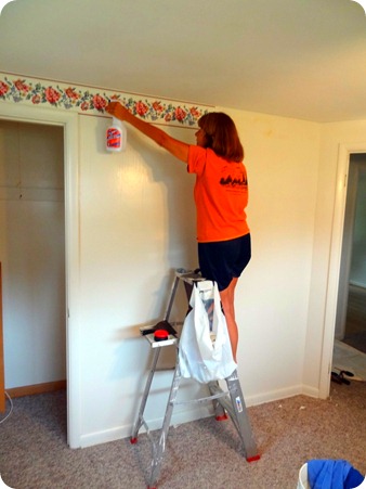 Marsha removing wallpaper.
