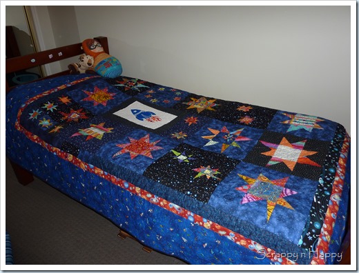 wonky star space quilt on bed