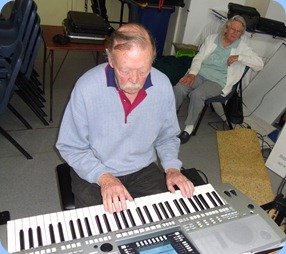 Colin Crann playing his Yamaha PSR-710 whilst Yvonne, his wife, watches on intently